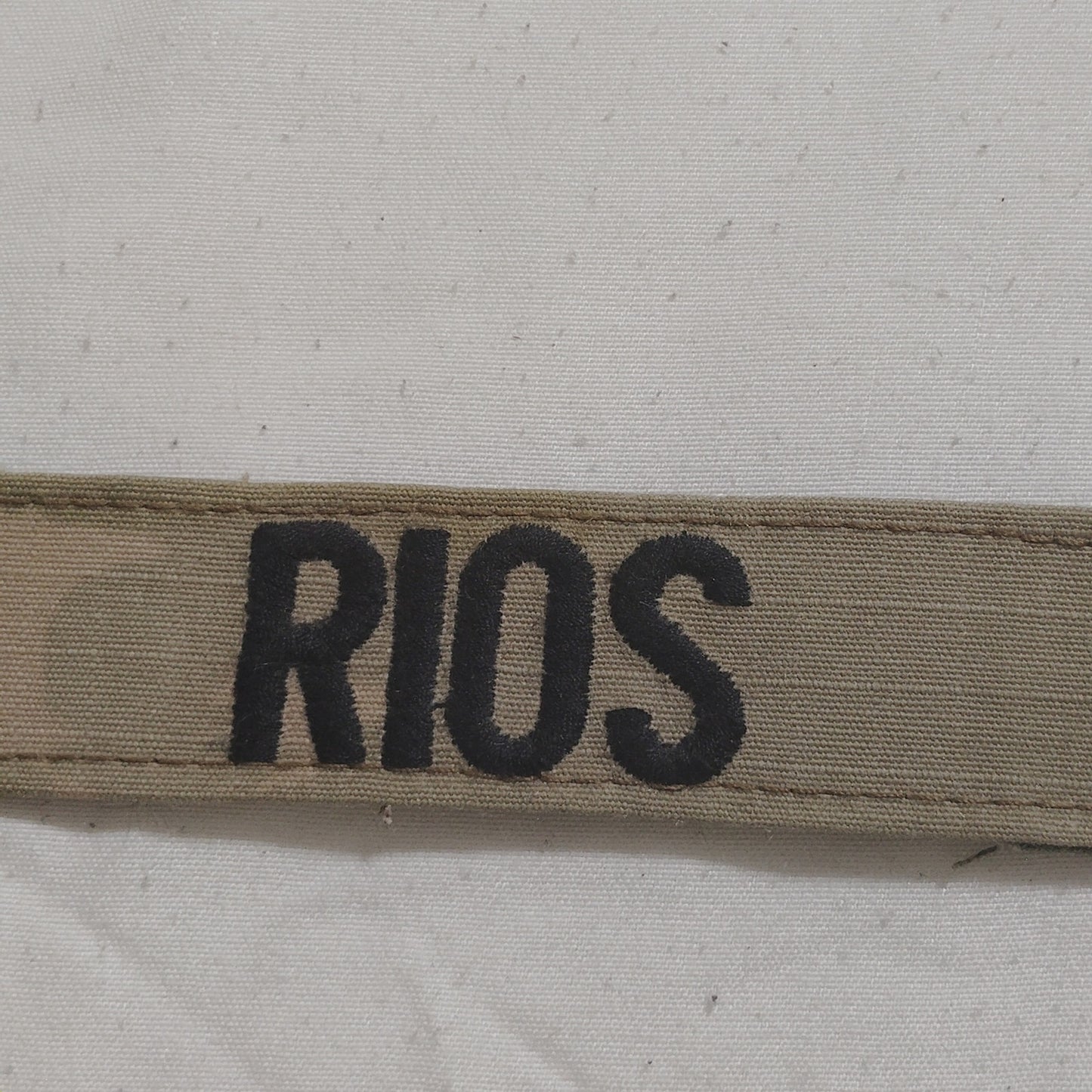 Name Tape “RIOS” – Desert Tan / Khaki – Hook Back – 5" × 1" – Novelty Patch
