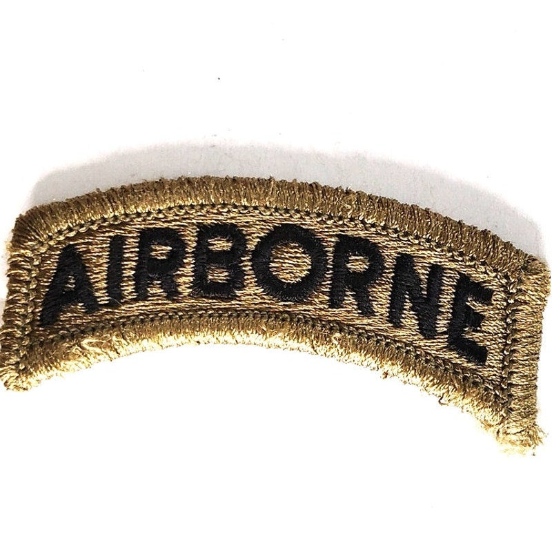 US Army Airborne Tab Novelty Patch Subdued Black on Green 2‑1/2" × 1" Hook Back