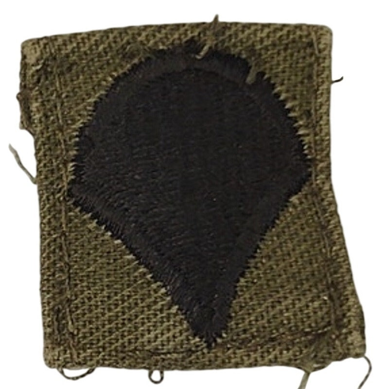 US Army Specialist E‑4 Cap Device Patch Black on ODG TE Sew‑On 1" × 7/8"